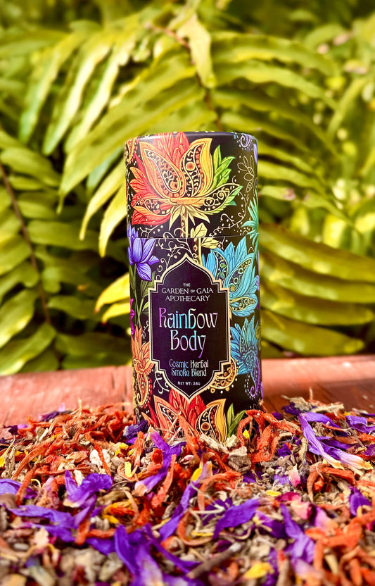 Colorful bottle labeled 'Rainbow Body' on a bed of dried flowers with green leaves in the background
