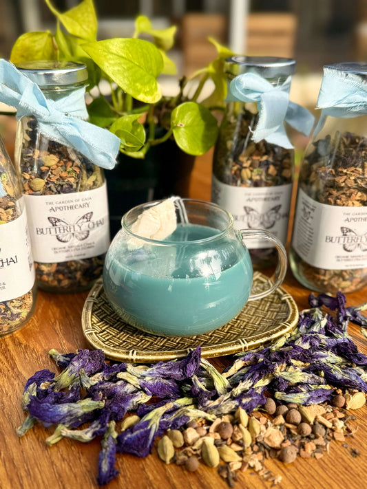 Butterfly Chai-Ceylon Tea & Whole Spice Blend in a glass with dried spices and fresh butterfly pea flowers.