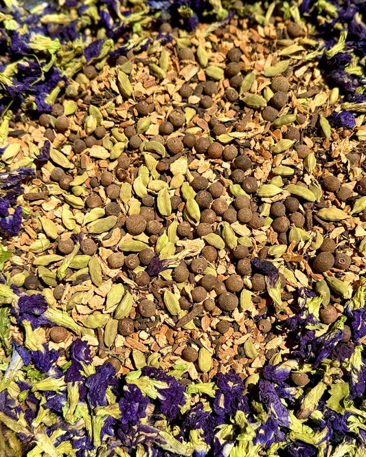 Butterfly Chai-Ceylon Tea & Whole Spice Blend featuring colorful spices and butterfly pea flowers.