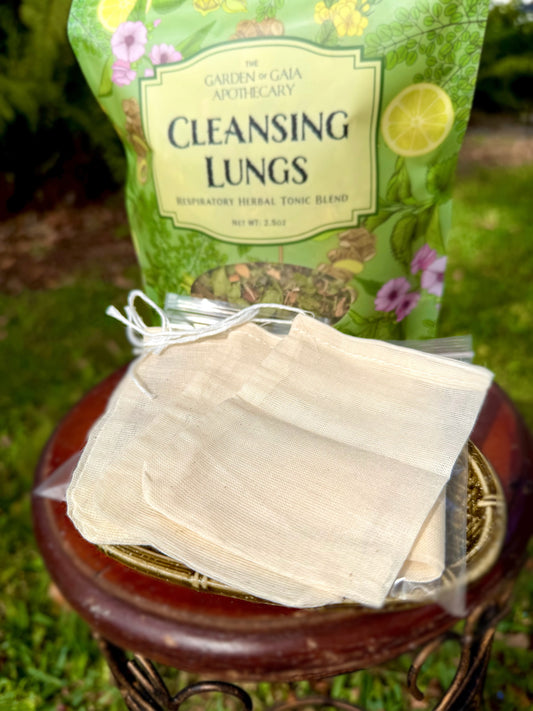 Herbal tea bags unbleached cotton reusable sustainable eco friendly displayed on a wooden stool outdoors.