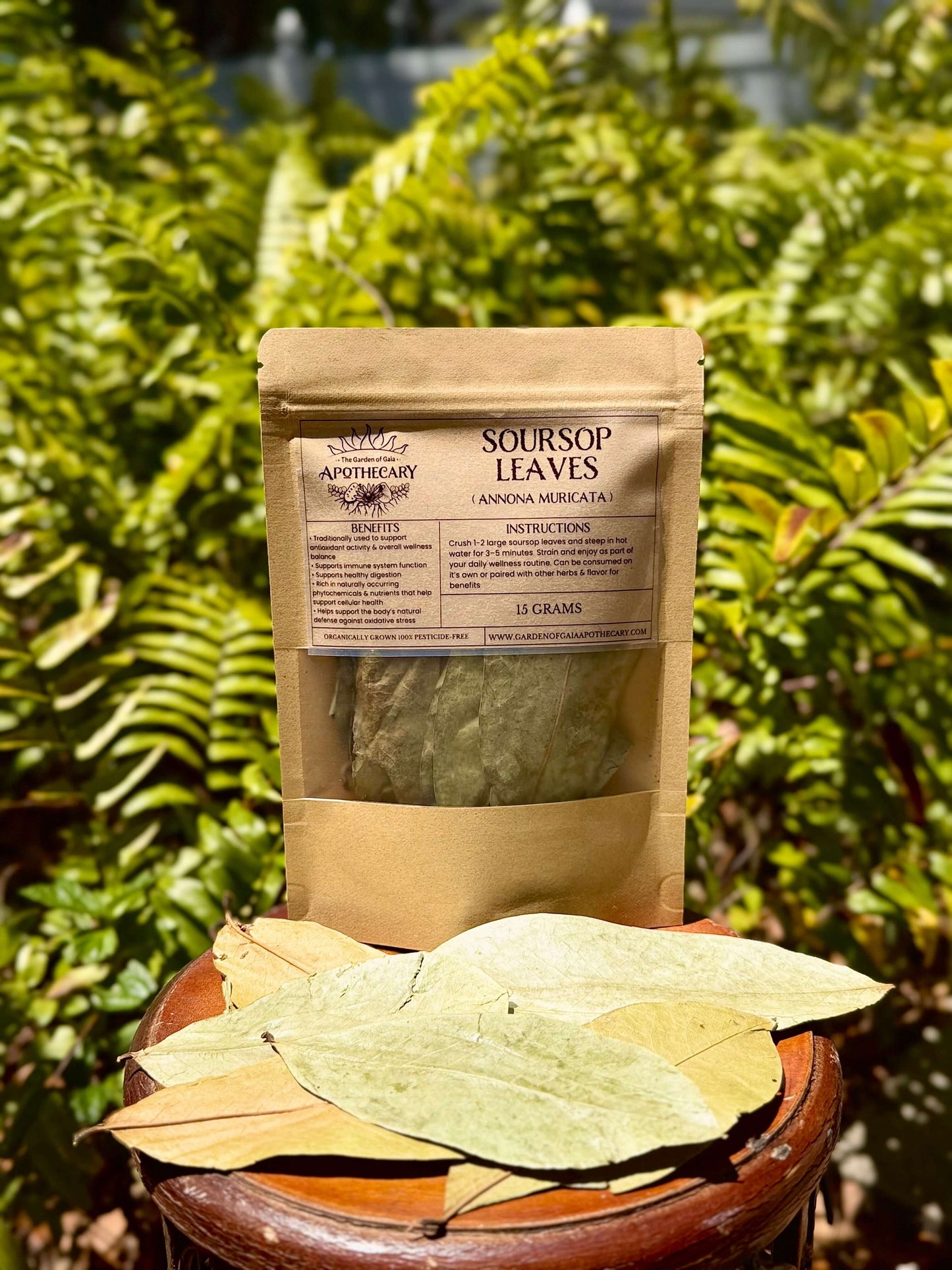 Soursop Leaves-organic whole leaves in resealable package with text and dried leaves on wooden table.