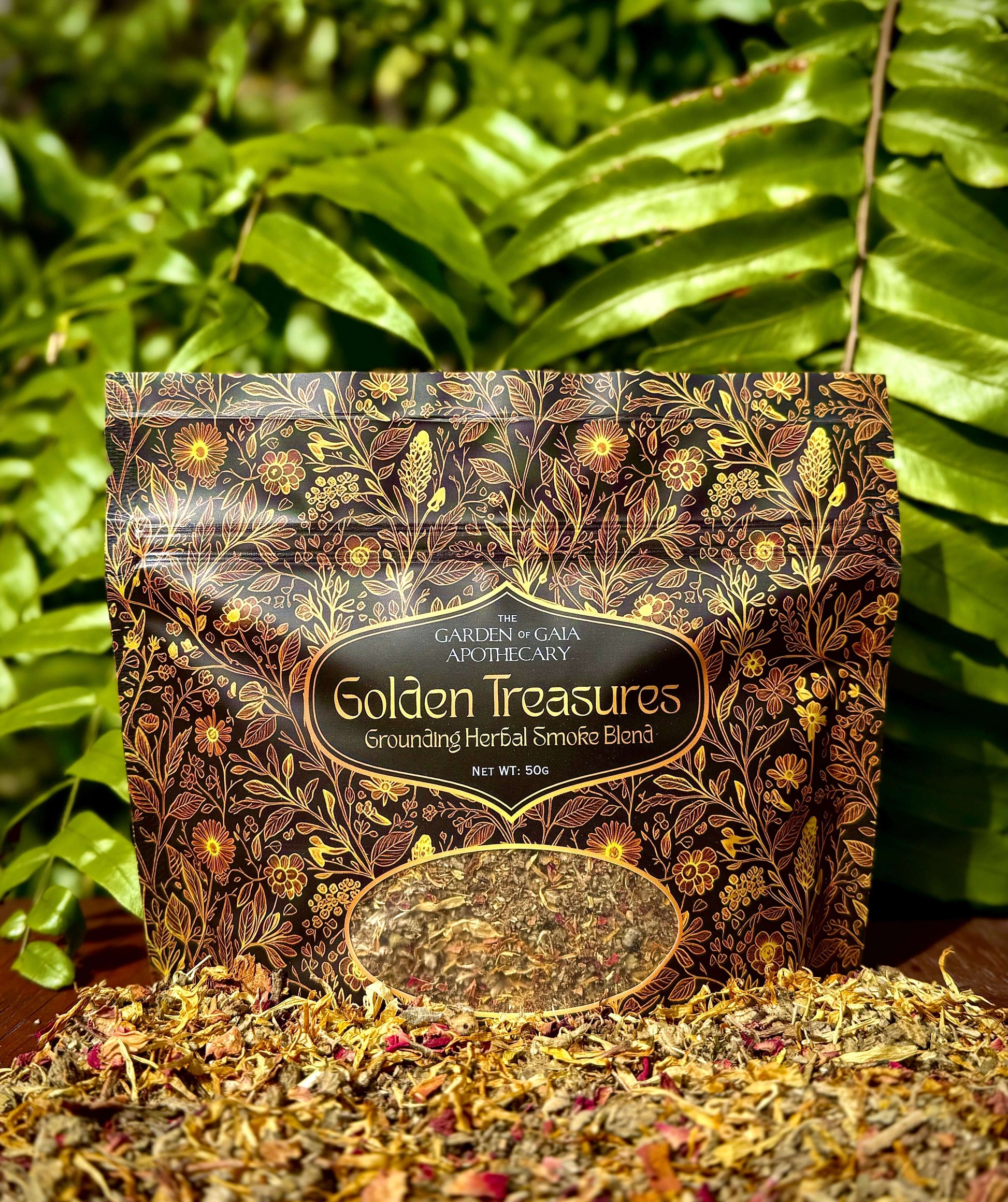 Golden Treasures-herbal smoke blend package surrounded by herbal ingredients on a wooden surface.