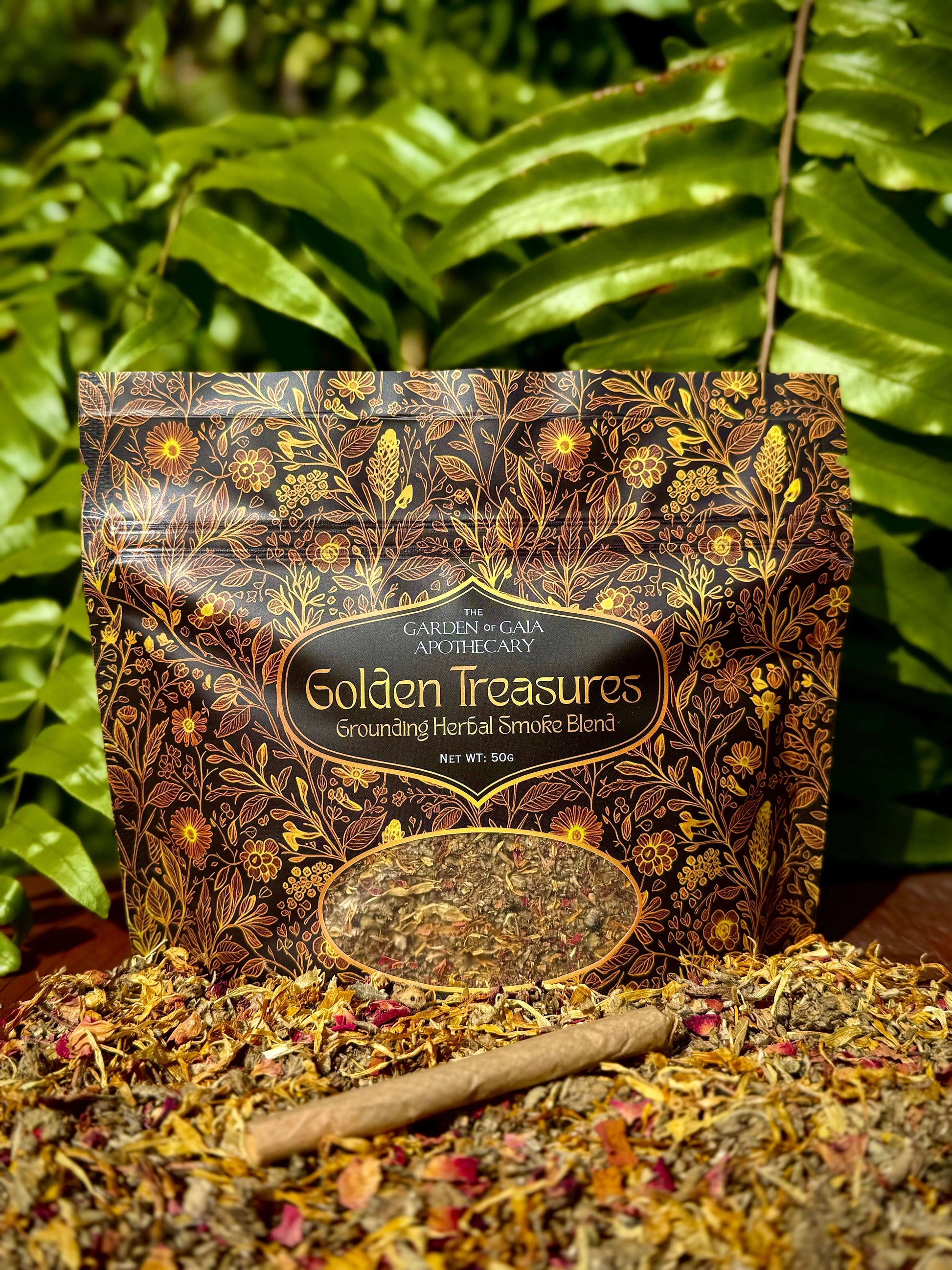 Golden Treasures-herbal smoke blend pack with herbal ingredients on a wooden surface and greenery in the background.