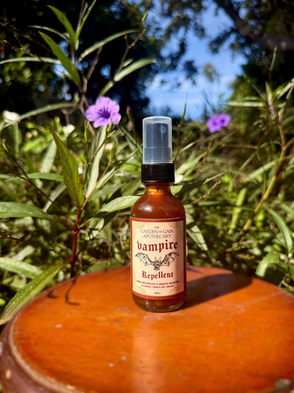 Vampire Repellent Non-Toxic Herbal Bug Spray bottle in a natural setting surrounded by plants.