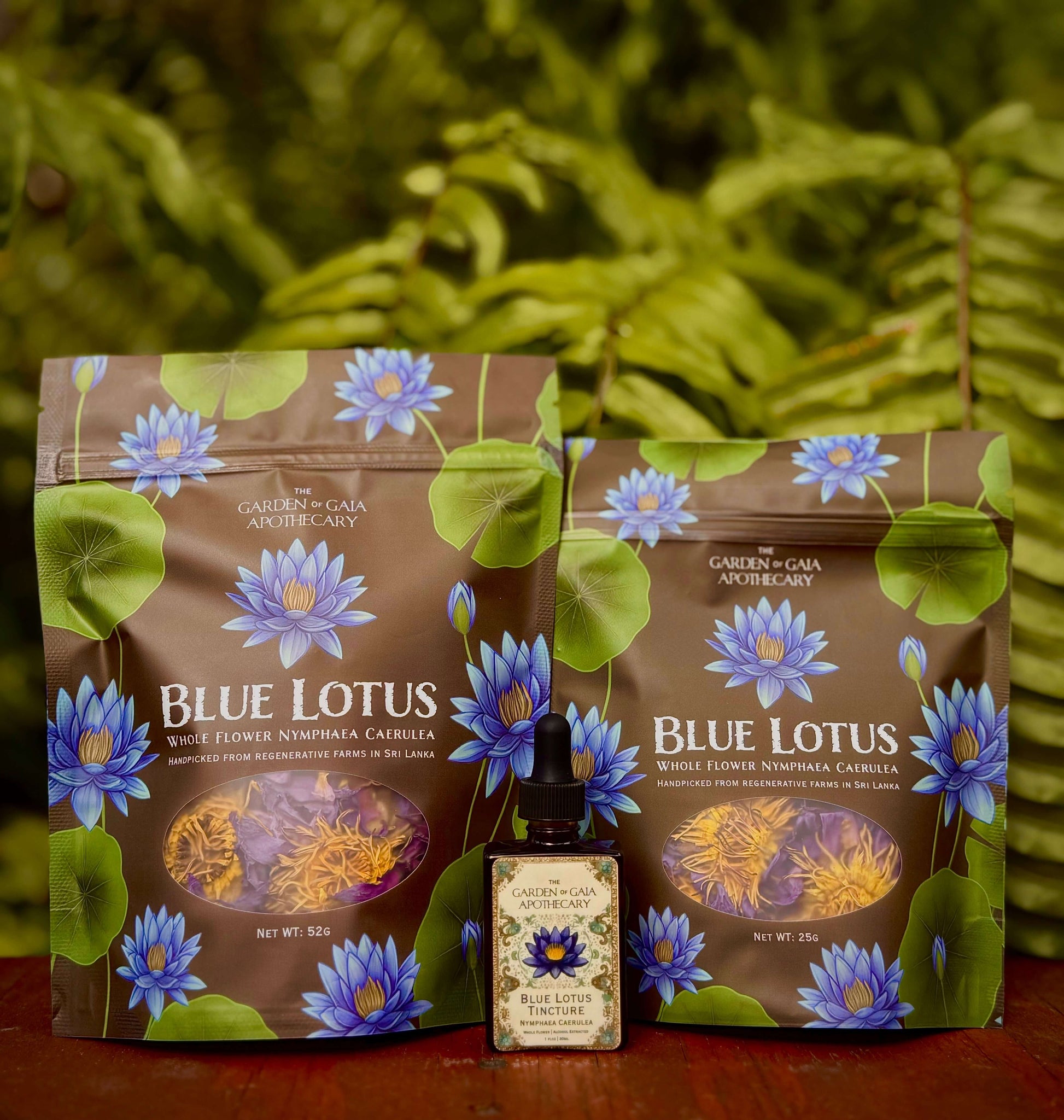 Blue Lotus product packaging with a bottle on a wooden surface and green foliage background. Blue Water Lily Flowers - Organic Whole Flower